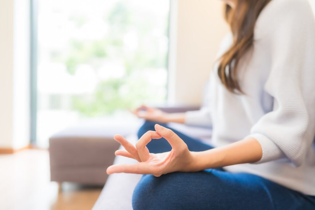 Portrait beautiful young asian woman meditation on sofa